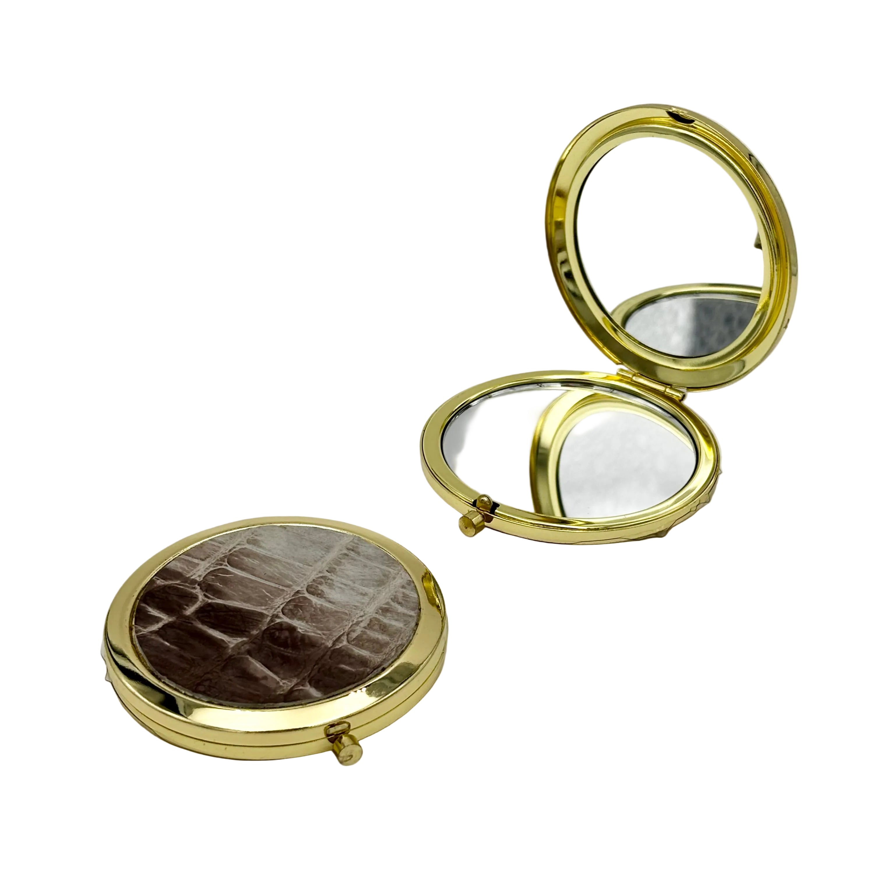 Himalayan alligator gold compact mirror open showing dual mirrors — standard and 5x magnification — with alligator skin exterior