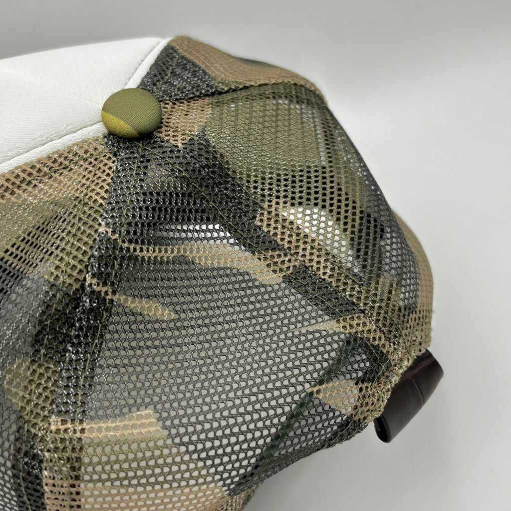 Close-up of camo mesh back panel and dark brown alligator leather tab on Frostytch trucker hat