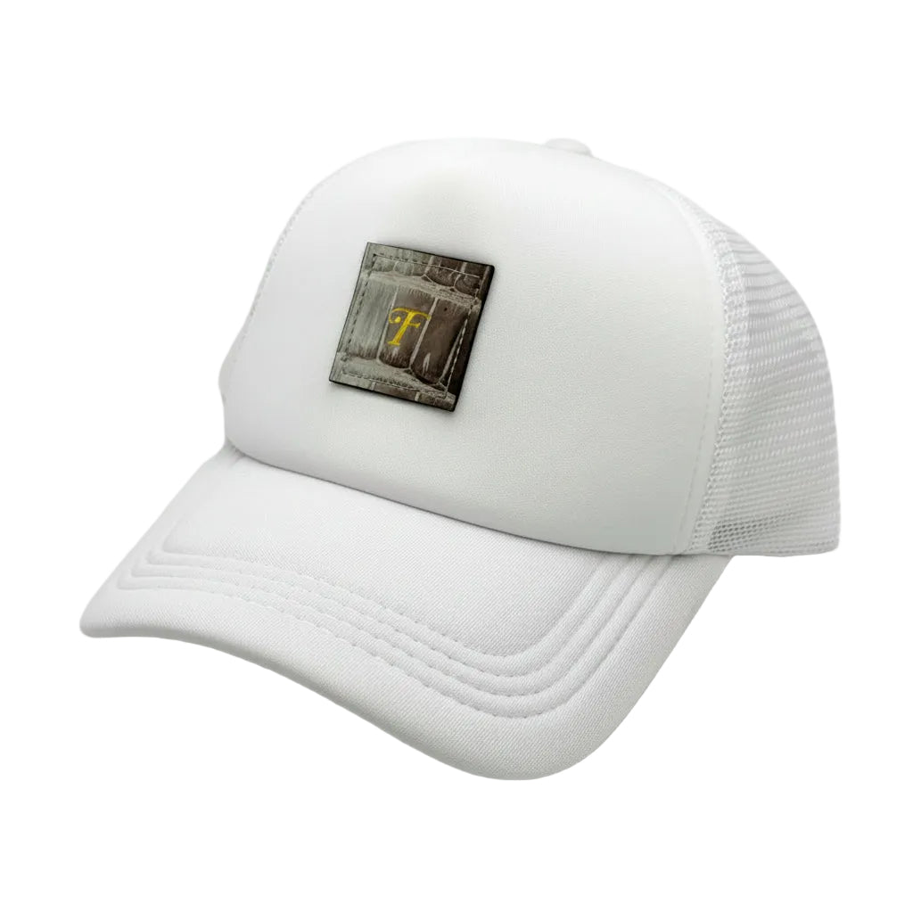 Close-up of Himalayan alligator leather patch and mesh back panel on white trucker hat