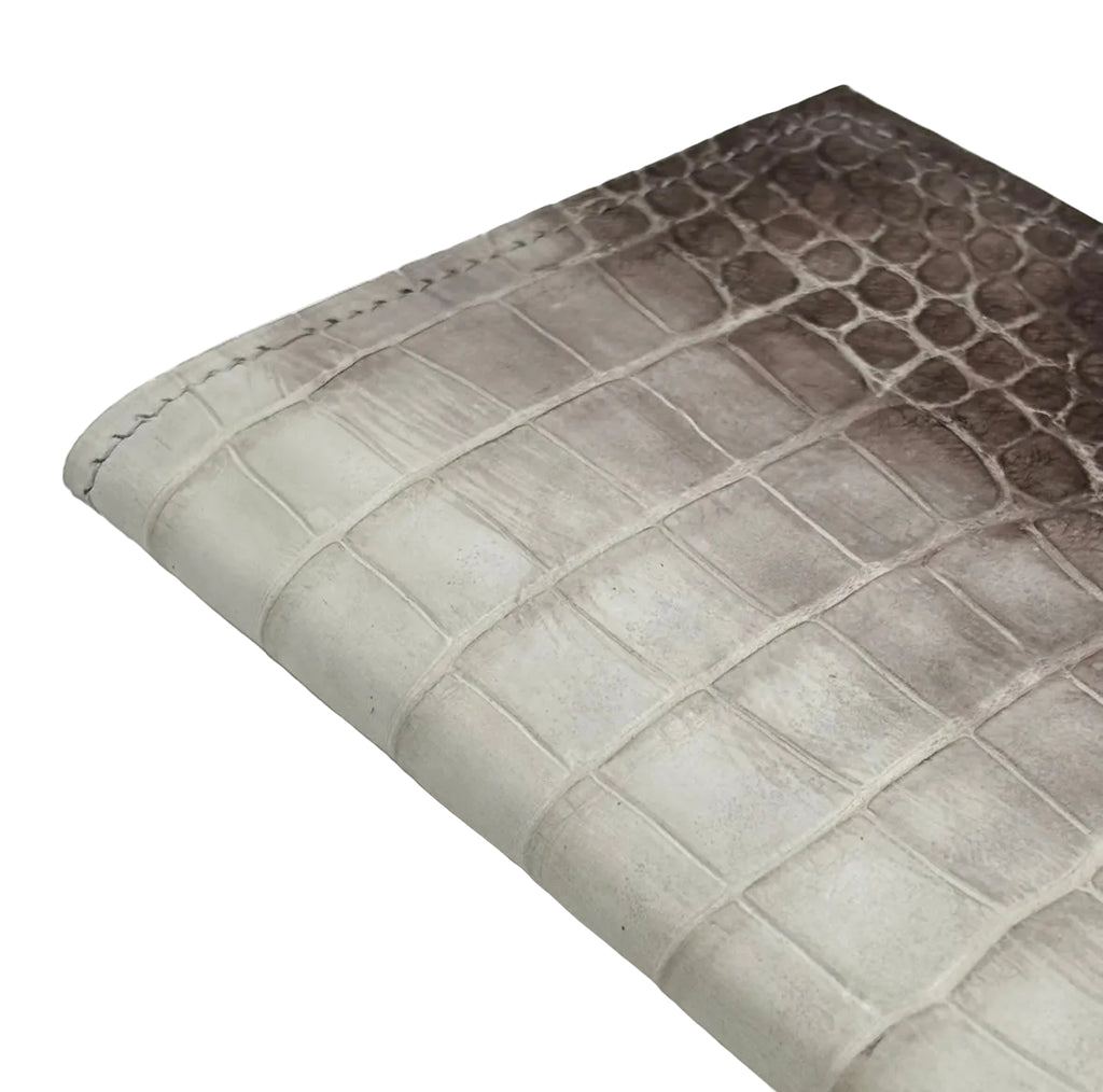 Close-up of Himalayan alligator leather texture showing natural gradient from ivory to dark brown