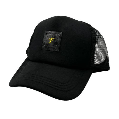 Black alligator trucker hat with black alligator leather patch and gold Frostytch monogram on front panel