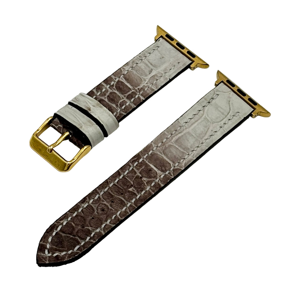 Himalayan alligator Apple Watch band with gold pin buckle and connector lugs, showing stone-grey to taupe gradient scale pattern