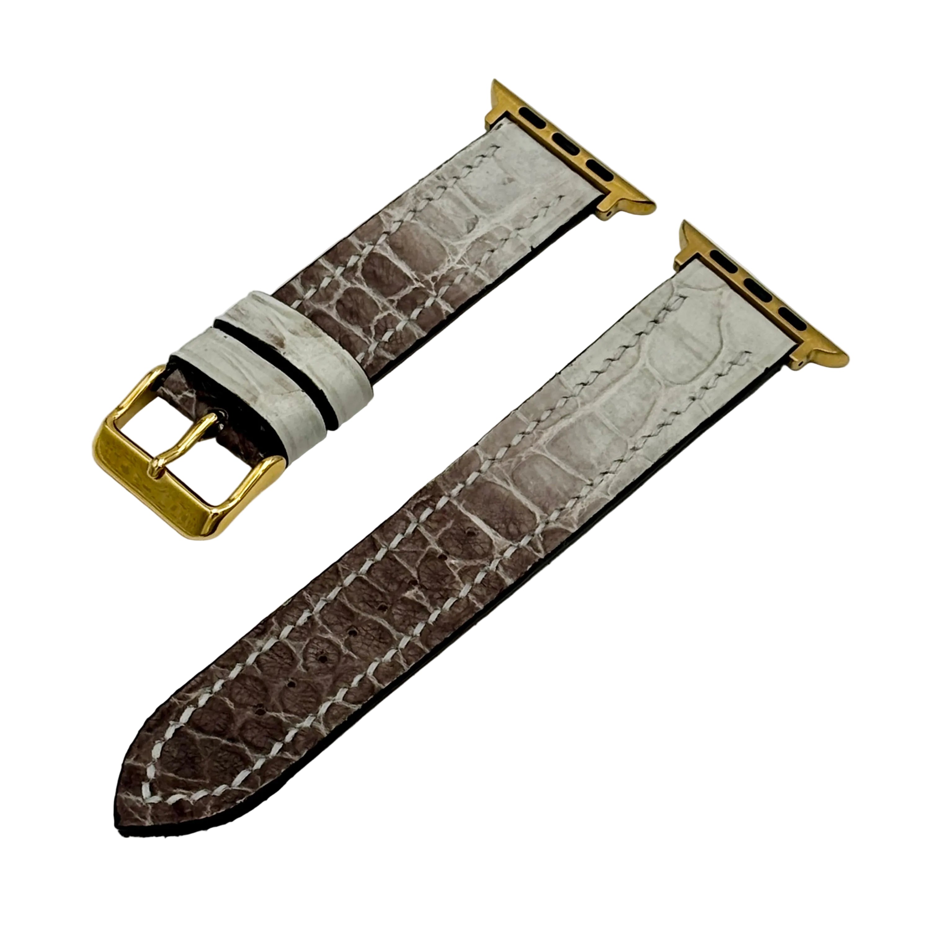 Himalayan alligator Apple Watch band with gold pin buckle and connector lugs, showing stone-grey to taupe gradient scale pattern