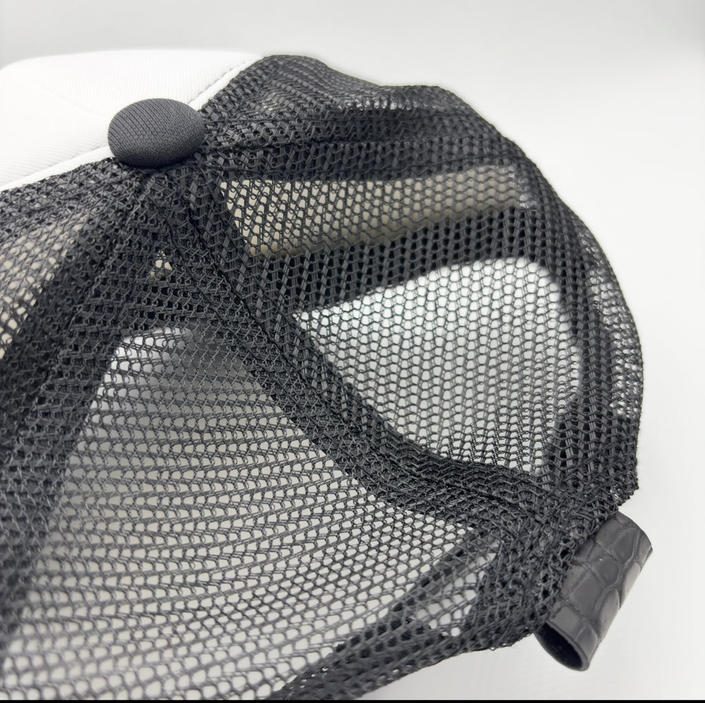 Black and white matte Nile crocodile trucker hat back view showing mesh panels and matching crocodile tab closure