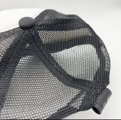 Black and white matte Nile crocodile trucker hat back view showing mesh panels and matching crocodile tab closure
