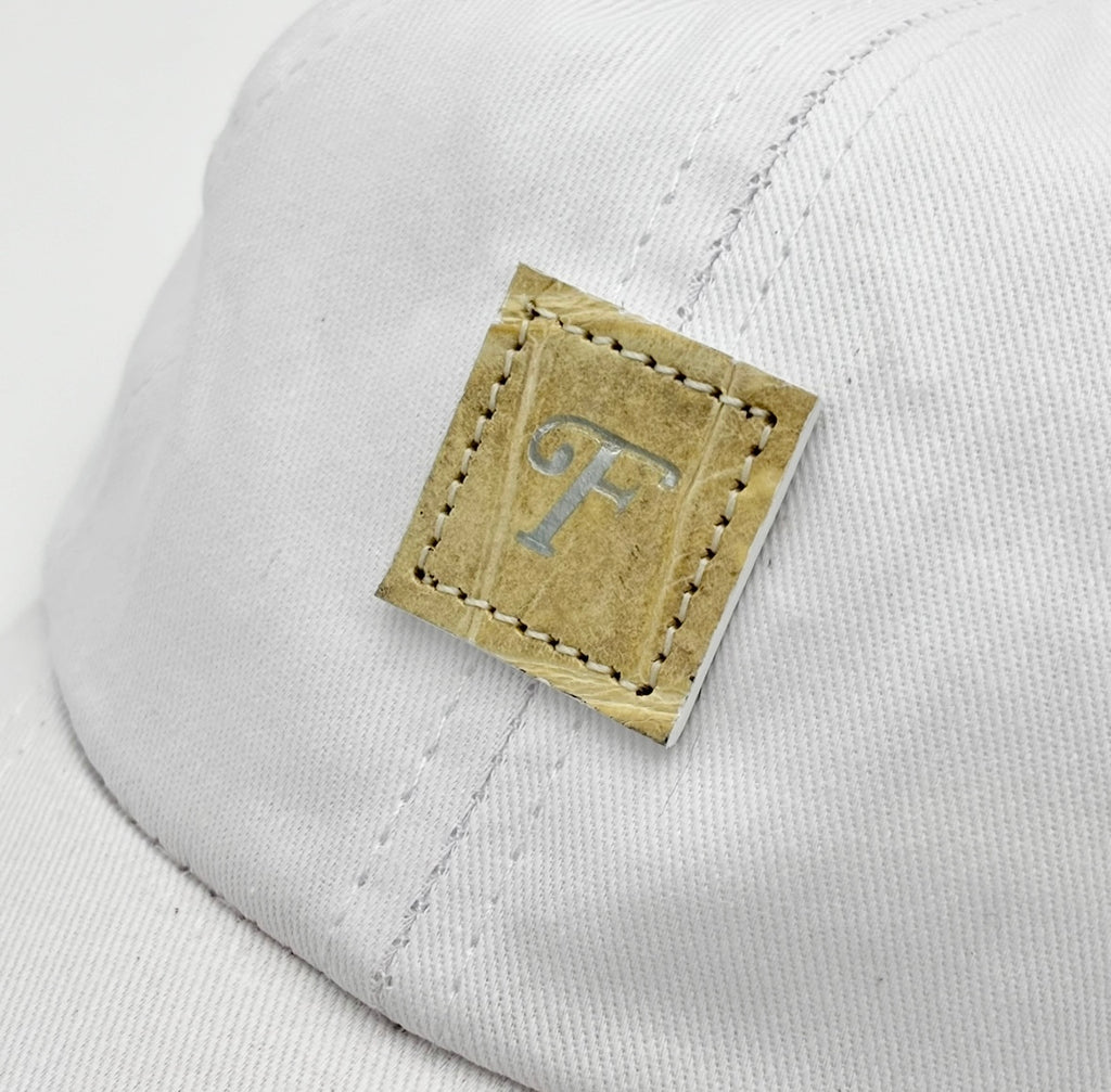Glazed natural alligator infant baby cap with elastic scrunchie back, white cotton twill body, full view