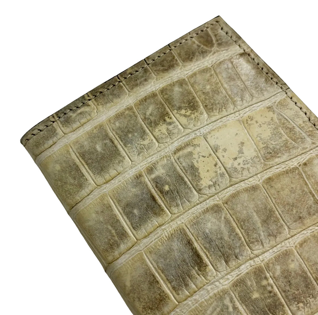 Glazed natural alligator passport cover — angled view showing dark brown saffiano interior lining