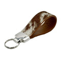 Brown-and-white cowhide loop key fob with light brown leather lining and polished silver hardware